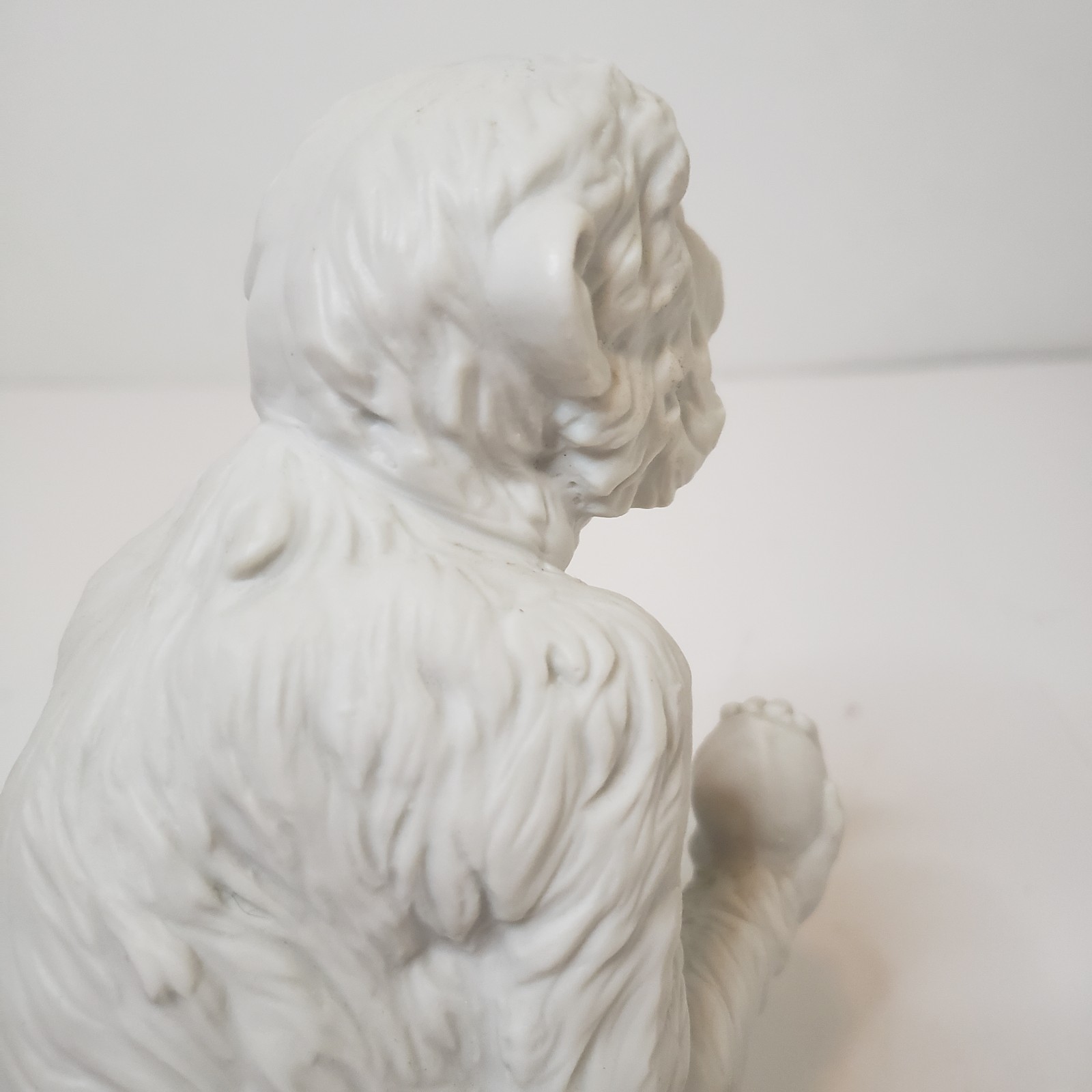 White Bisque Porcelain Sitting Monkey Holding Rock Figurine Vintage