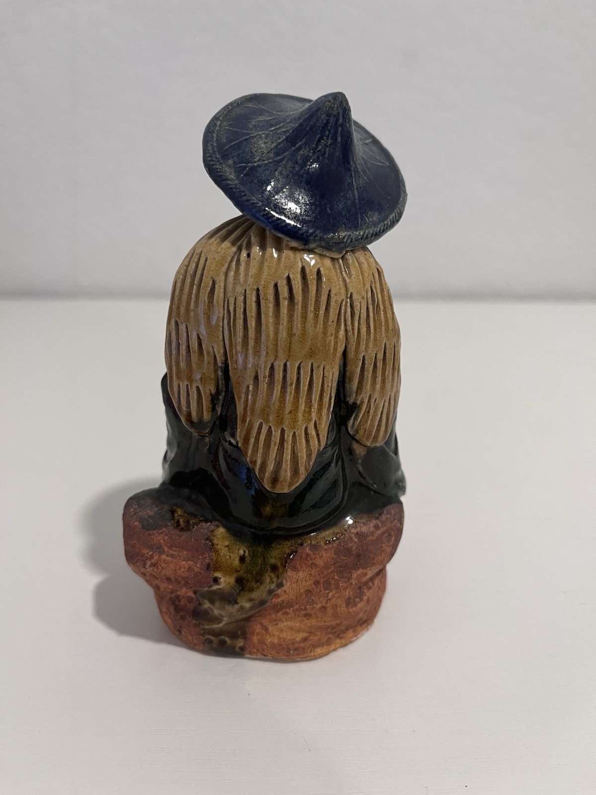 Vintage Chinese Ceramic Seated Mudman Figurine w/ Blue Hat Holding Pot