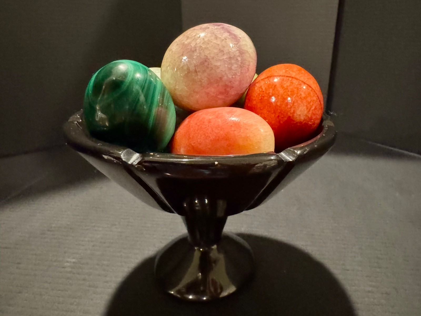 Alabaster black basket with 7 multi-colored eggs