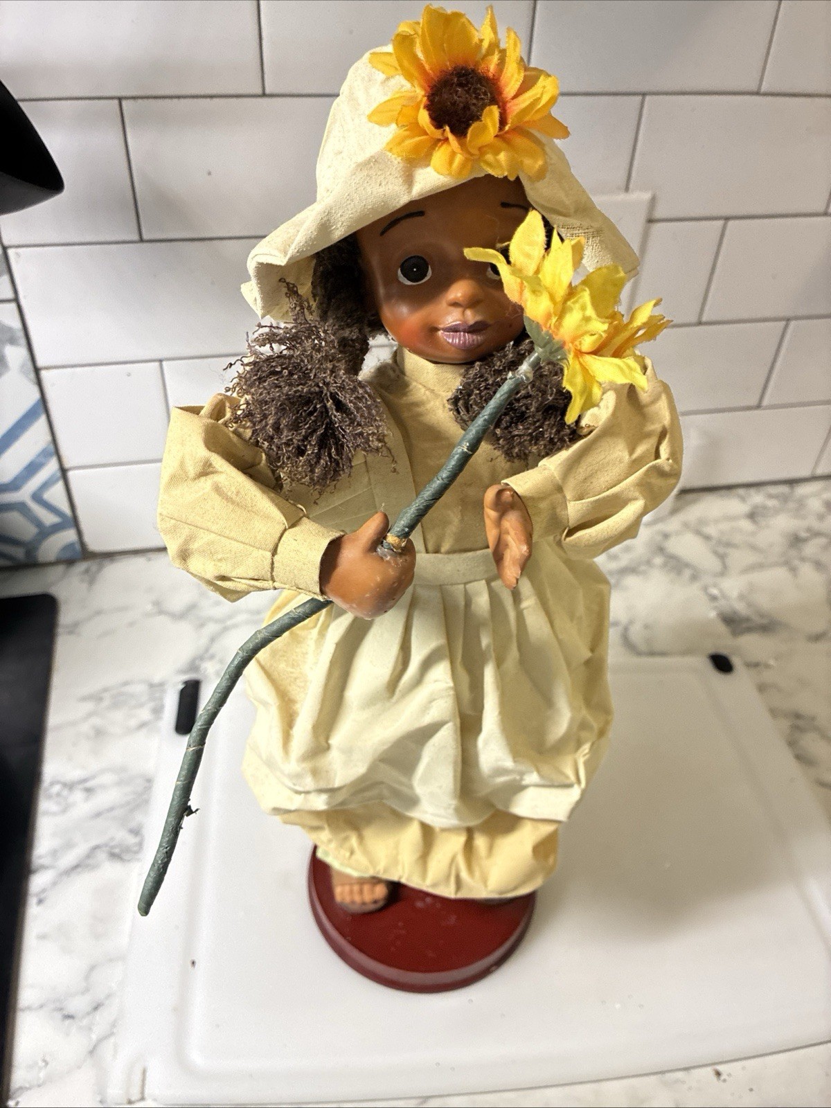 This 16 Inch Collectible Features A Dark Skinned Girl Figurine With Daisies
