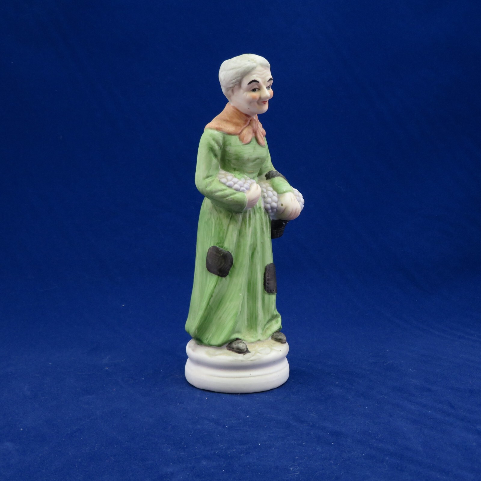 Old Woman Figurine Hand-Painted holding Basket of Grapes 8″ Tall Bisque Vintage