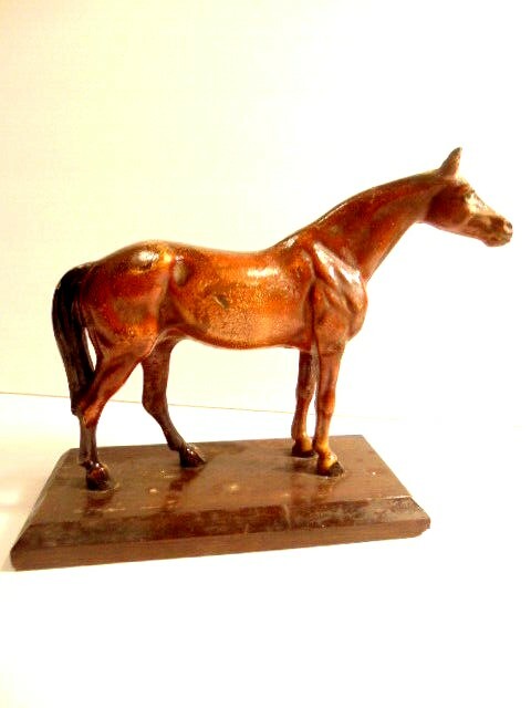 older cast iron brown horse on a wooden stand – about 5 3/4 inches tall