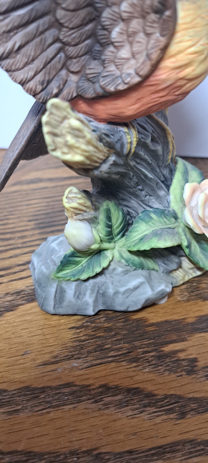 PORCELAIN ROBIN FIGURINE WITH FLOWER 7 5/8” H