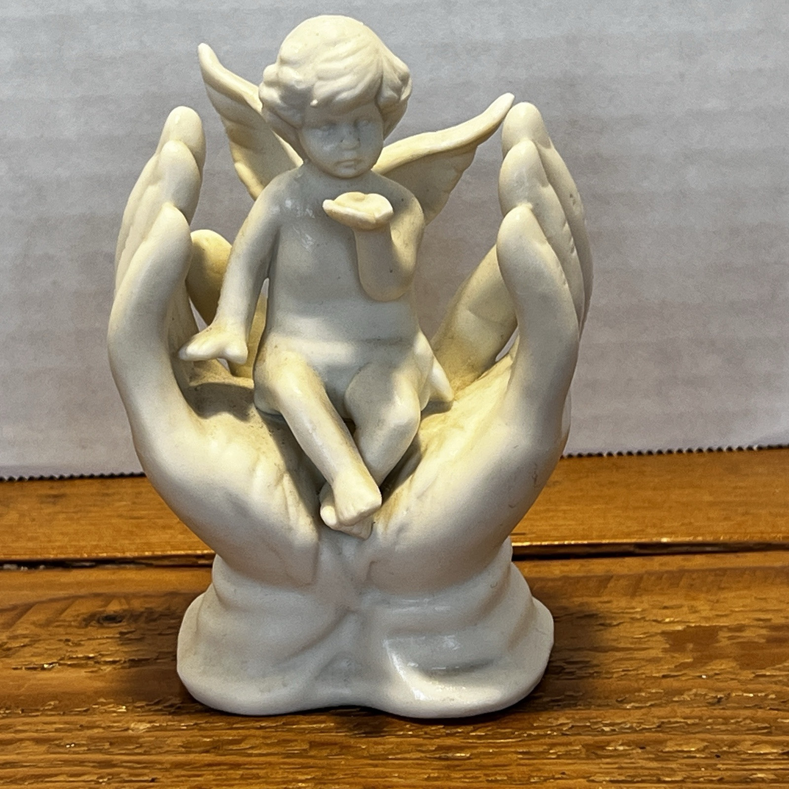 Vintage White Porcelain Figurine~Cherub Angel Sitting in Praying Hands~BEAUTIFUL
