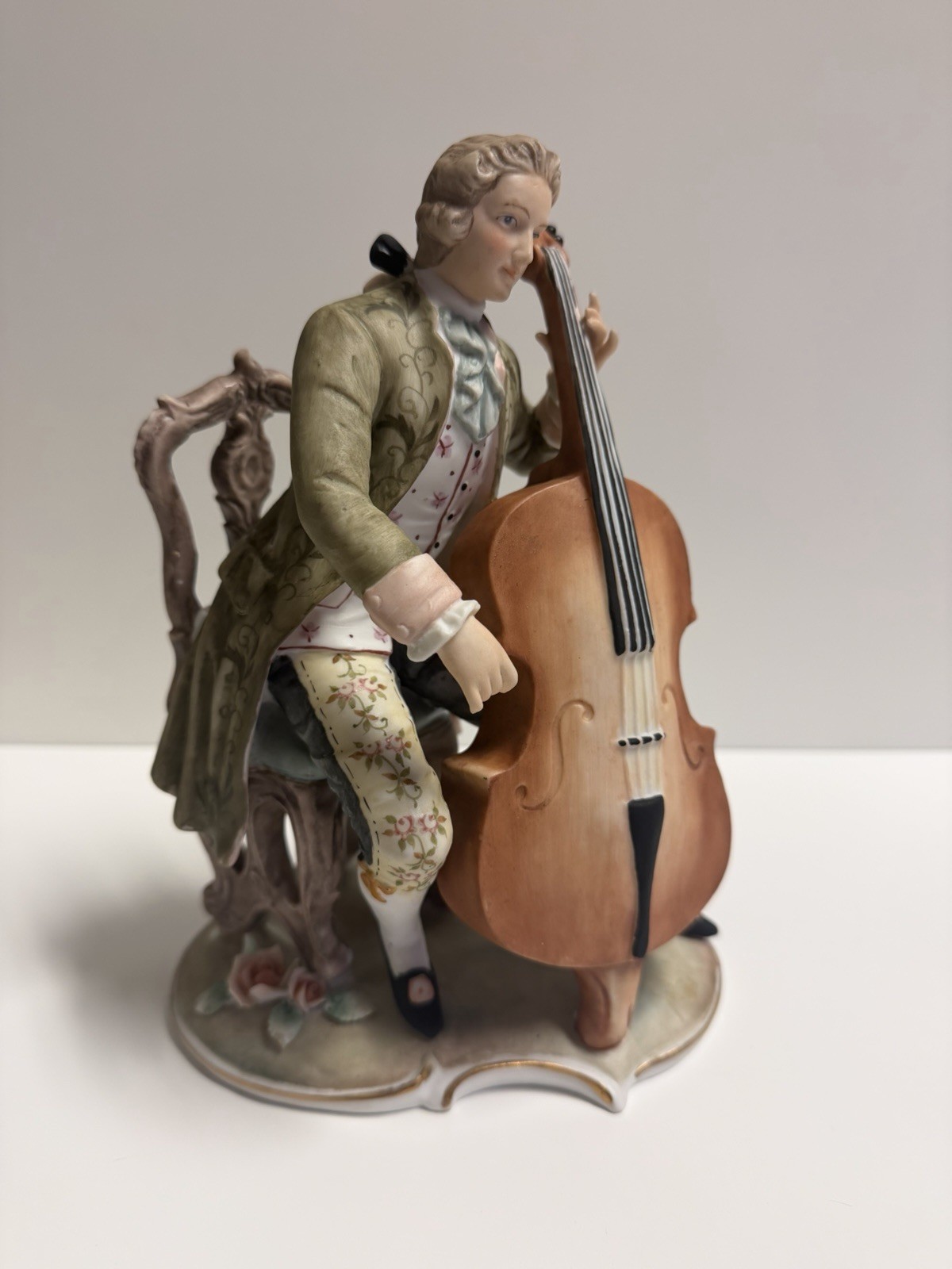 porcelain figurine of an 18th-century gentleman playing a cello