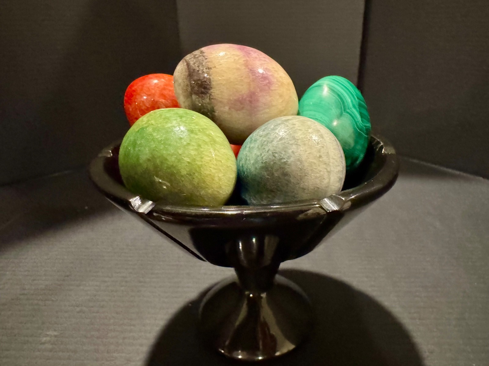 Alabaster black basket with 7 multi-colored eggs