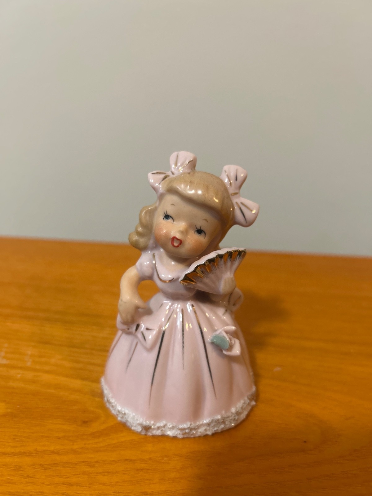 vintage ucagco girl in pink dress holding fan bell