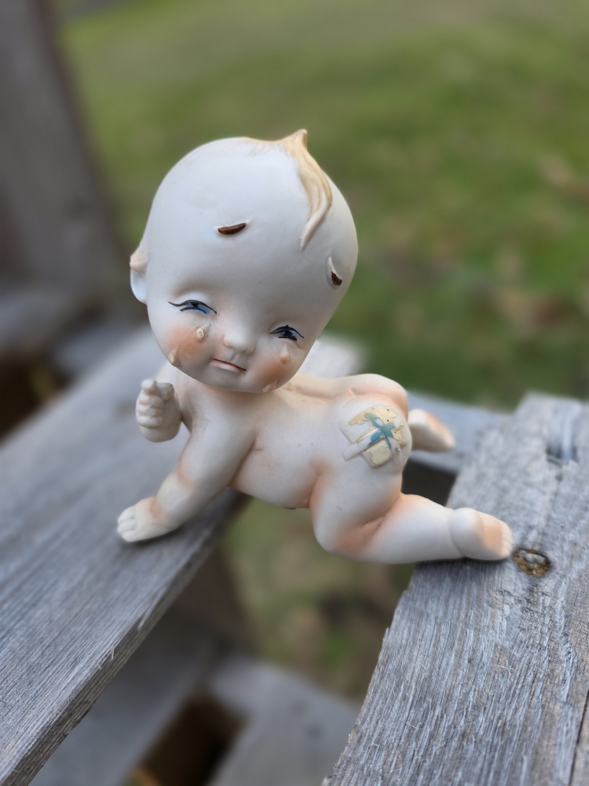Vintage Lefton Bisque Crying Kewpie Doll With bandage On Bottom 3.5” T x 4.25” W