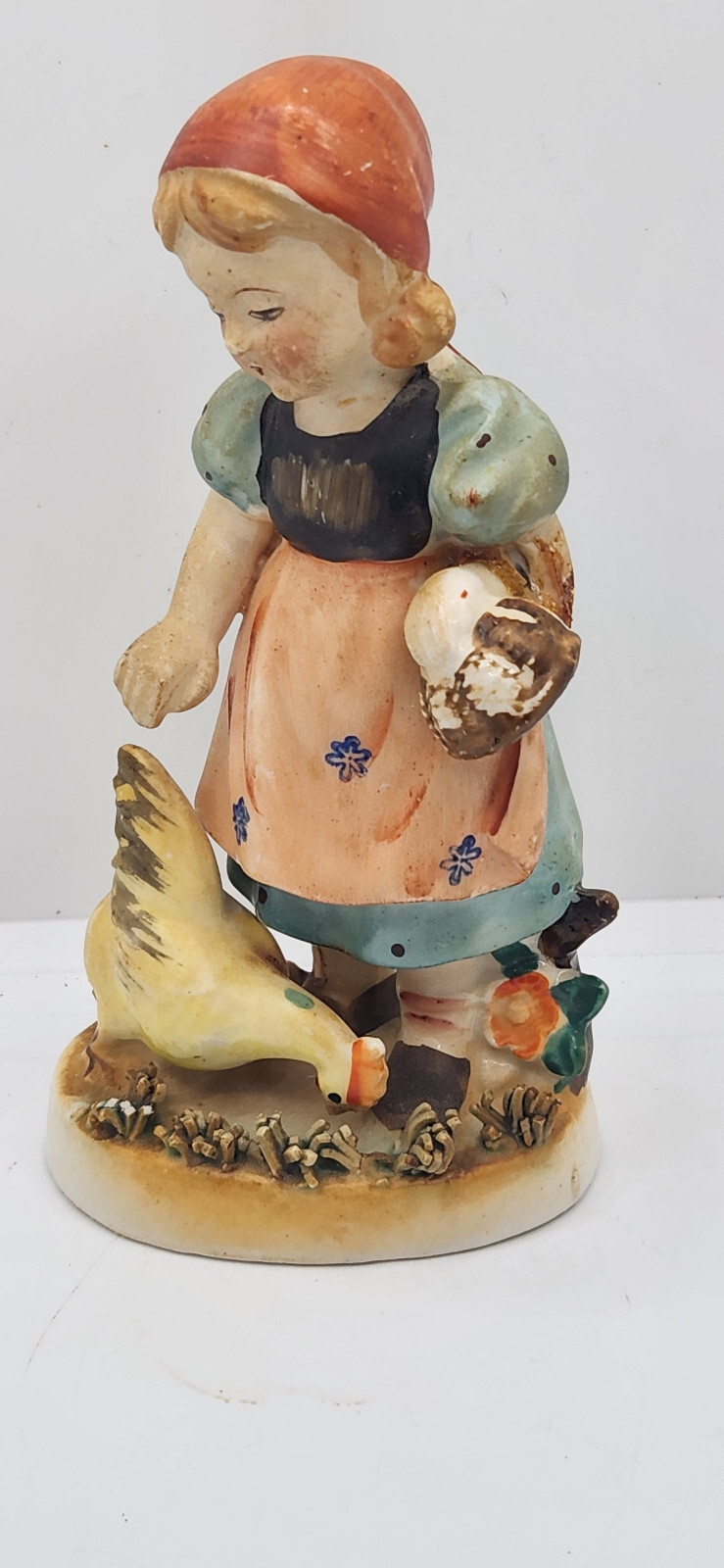 Little Girl Feeding Chicken (Unsure Marking)