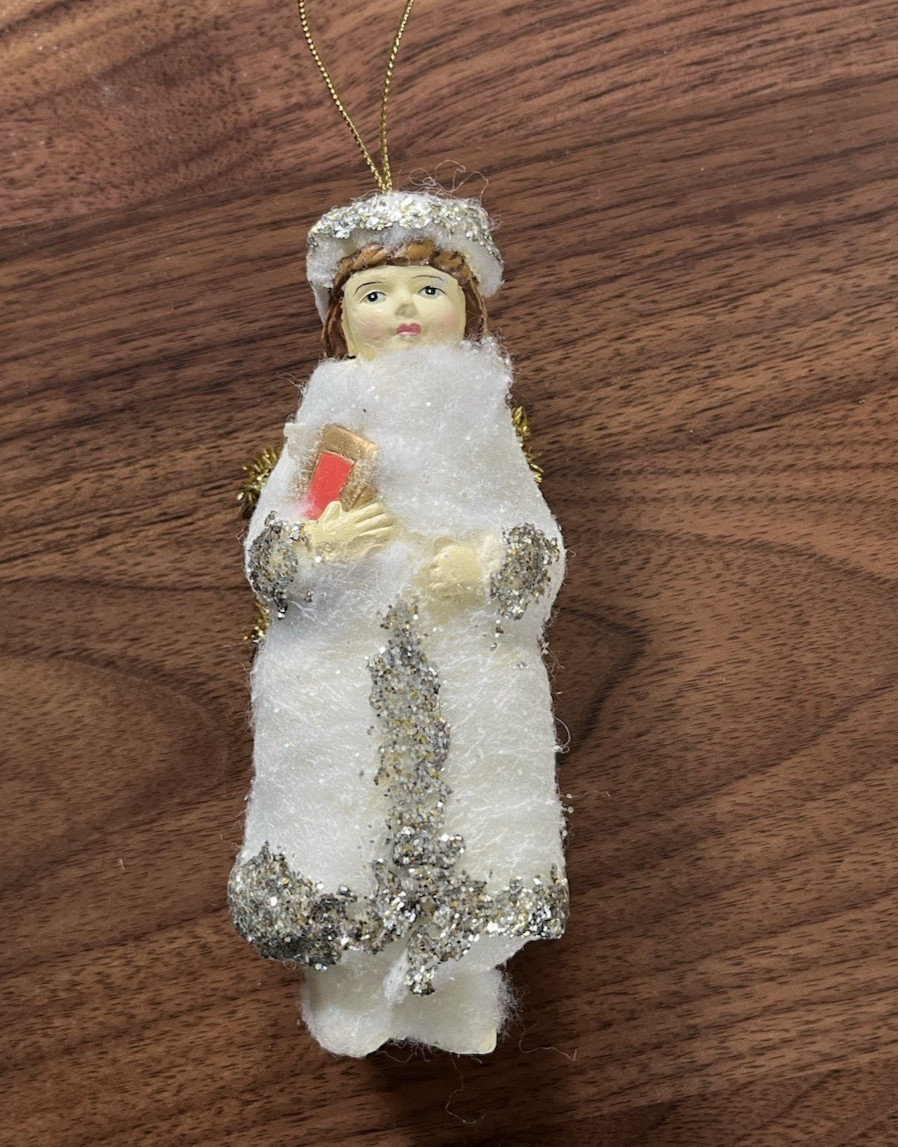 White 4 1/2” Angel With Silver Trim, Gold Colored Wings Holding A Book