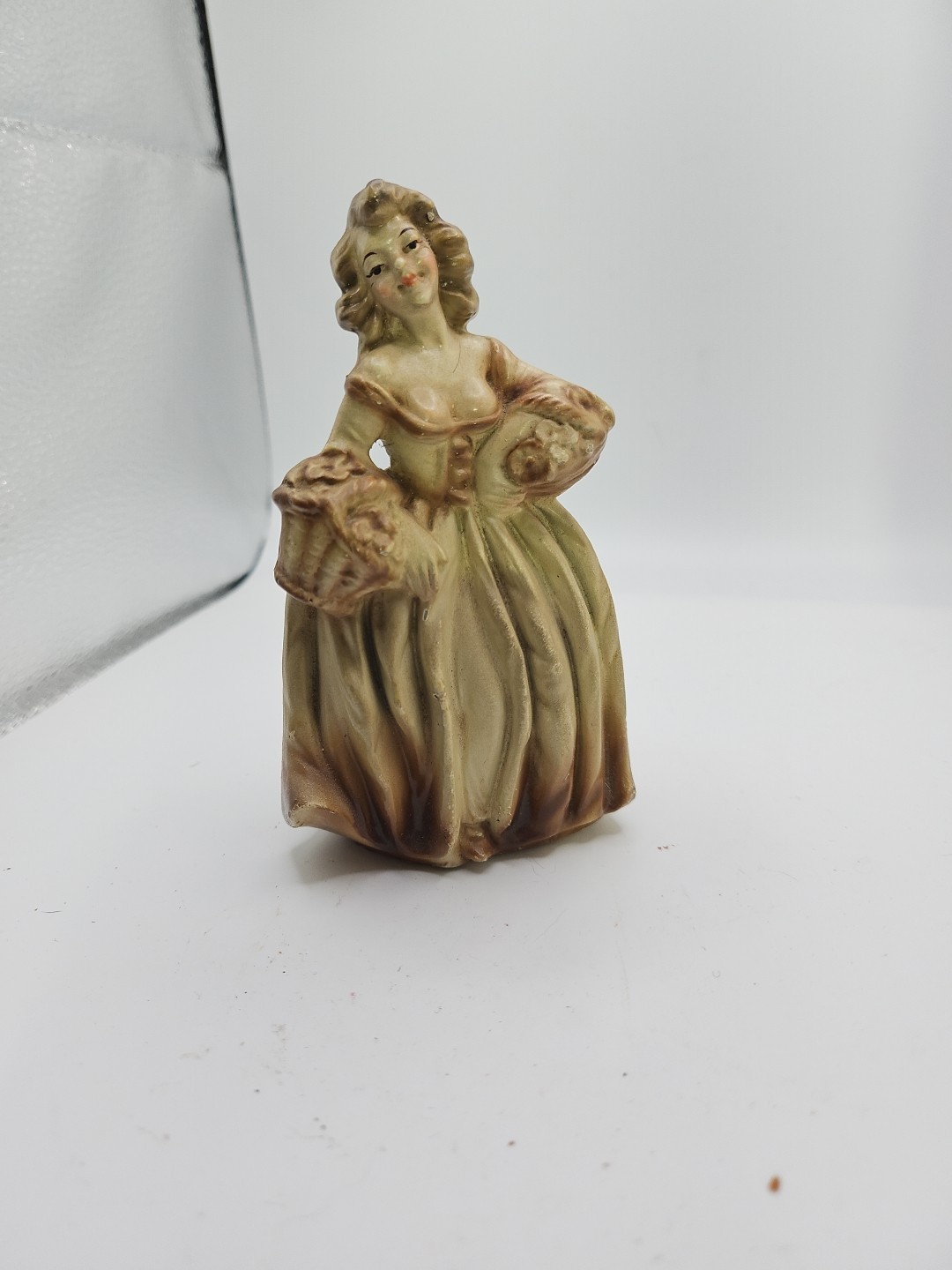 Antique Plastic Figurine Of A Woman Carrying Flowers