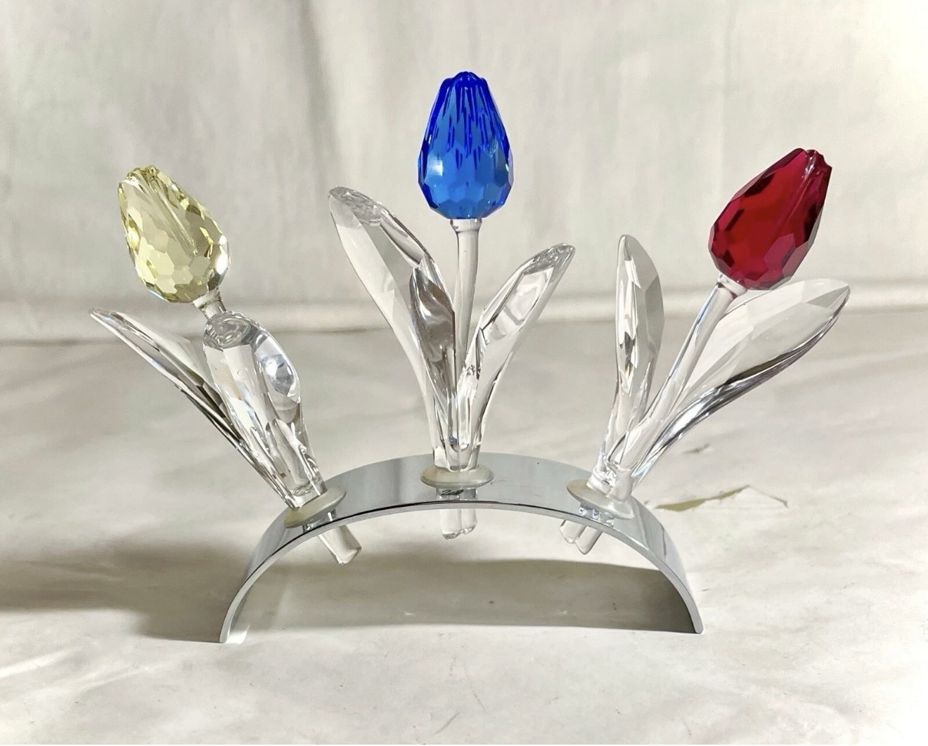 Swarovski Crystal set featuring red, yellow, and blue tulips on mirrored stand