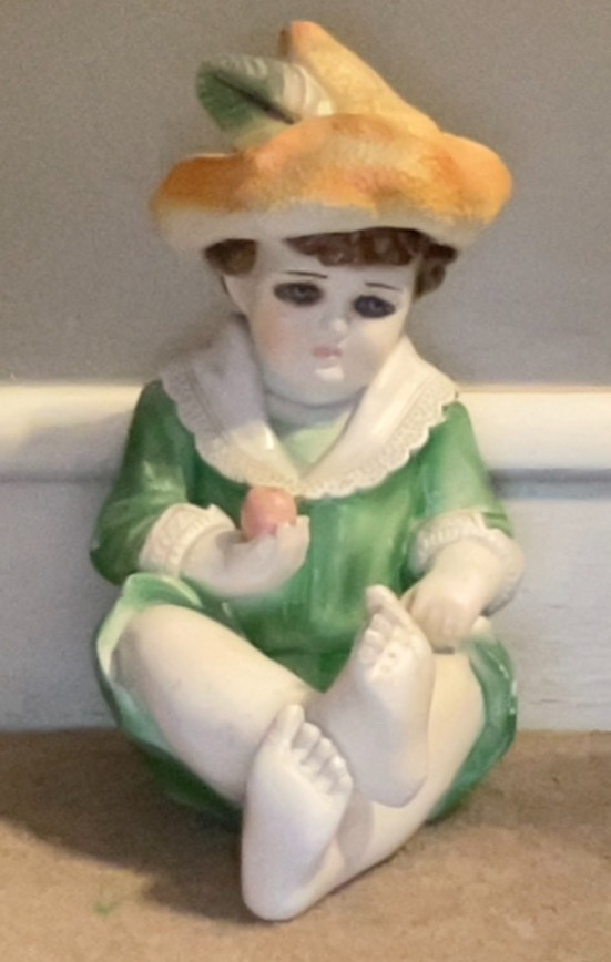 Large Ceramic or Chalk Figurine. Young Boy Holding an Apple. 12″ x 7″.