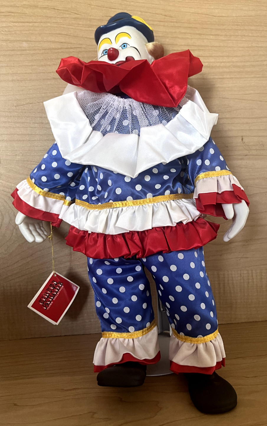 Circus Parade porcelain clown, 15.5 inches, red, white and blue, with stand