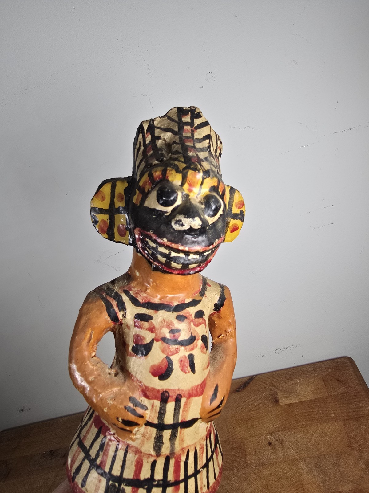 Folk art carved wood figure masked