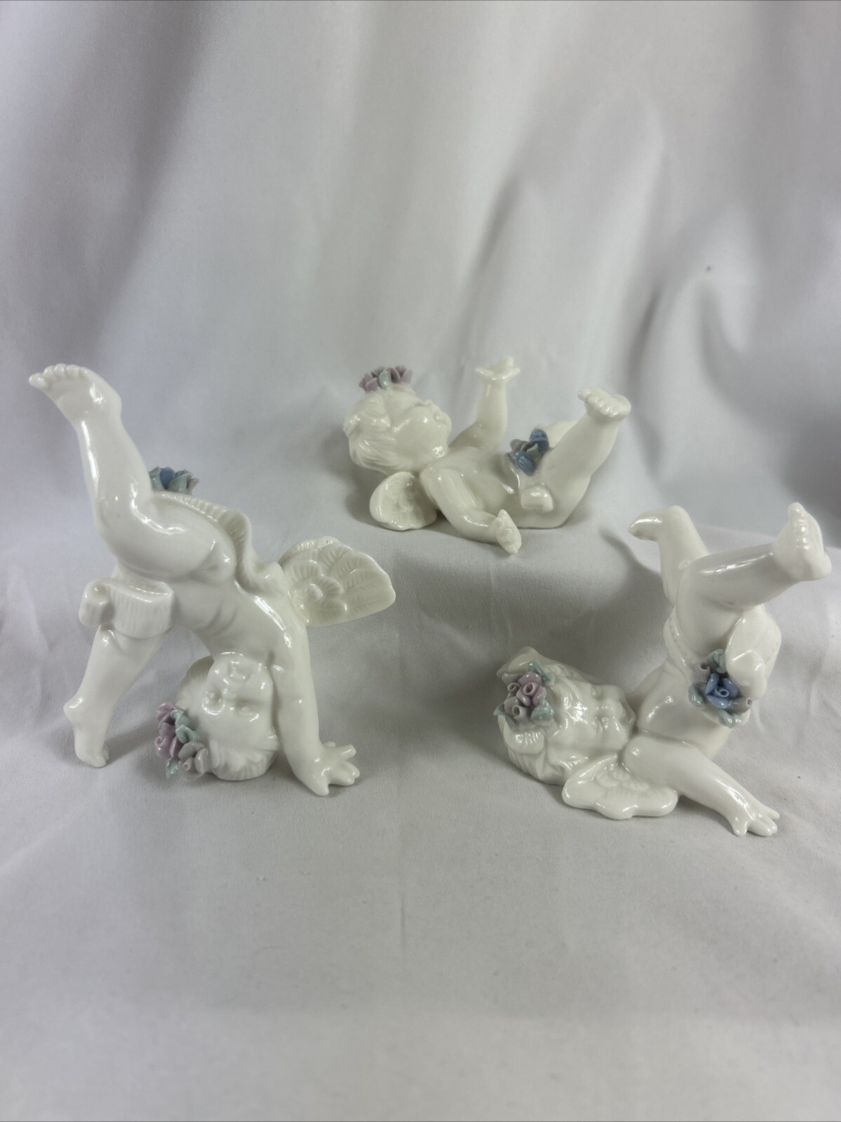 Tumbling Cherub Figurine Set Of 3 White Porcelain Flowers Playful 4”