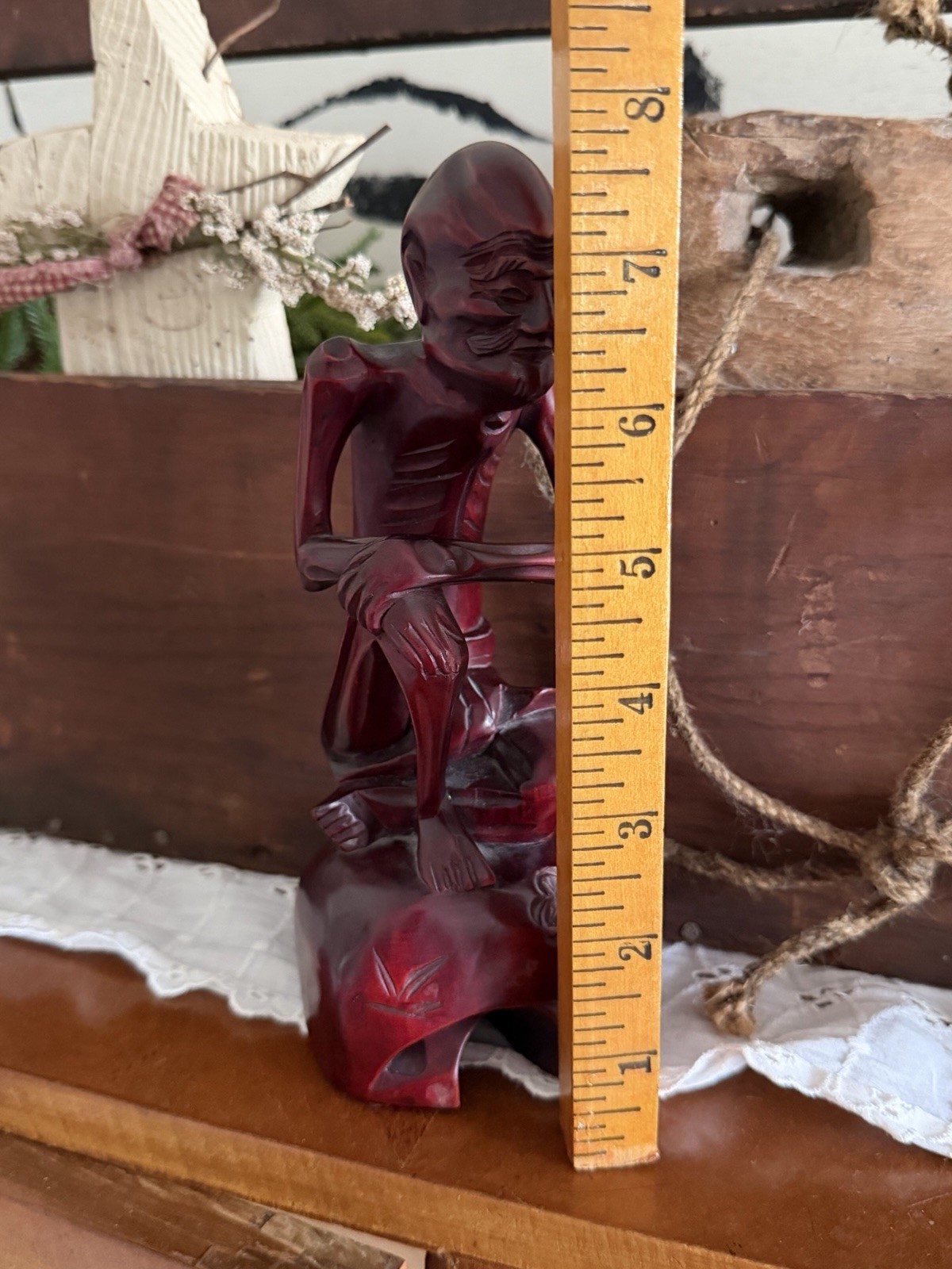 vintage hand-carved wood statue, often referred to as a “Fasting Buddha”
