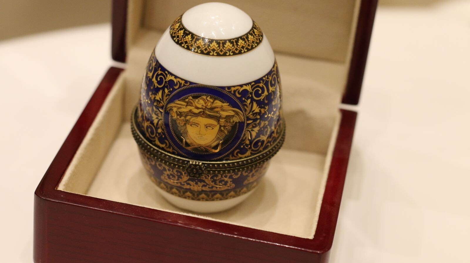 Versace Designs egg in white bohemian porcelain with blue and gold Medusa
