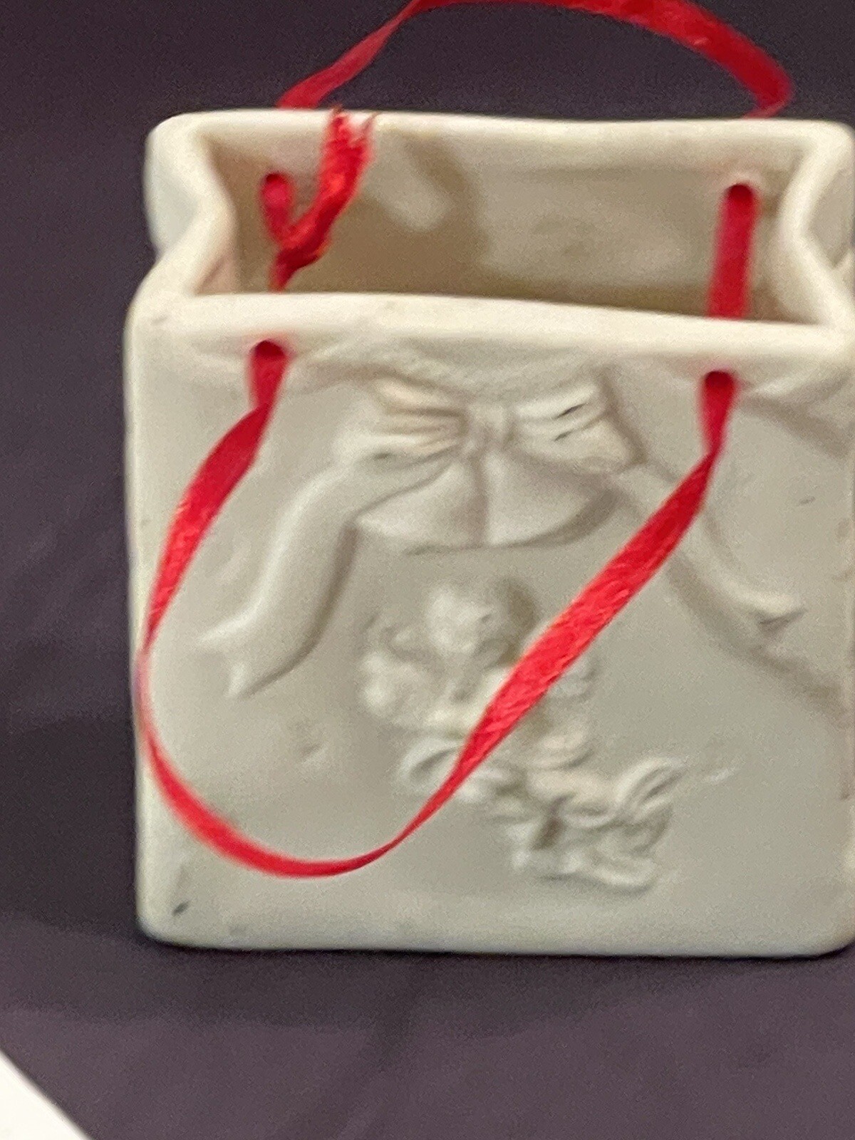 Autom China White Porcelain Cherub Bag With Red Ribbon Handle