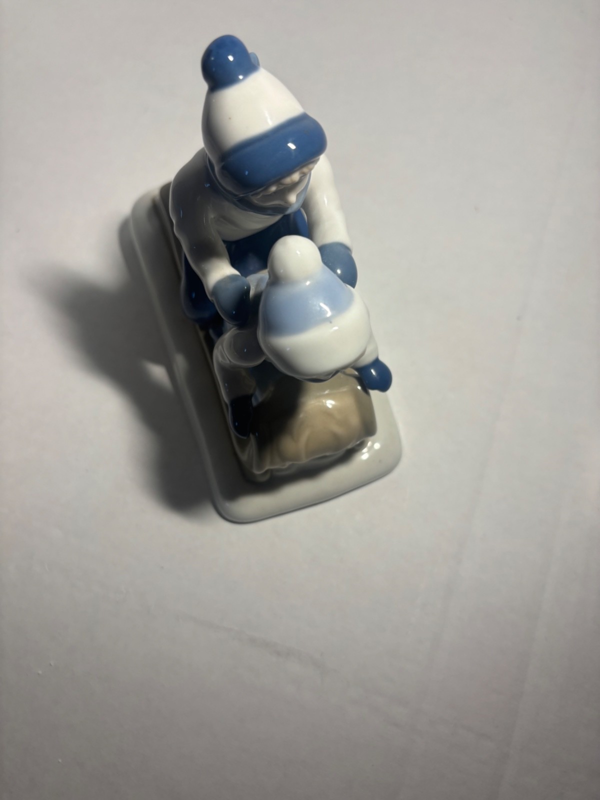 Children Sledding Figurine 6″L glazed ceramic gray & blue winter Christmas