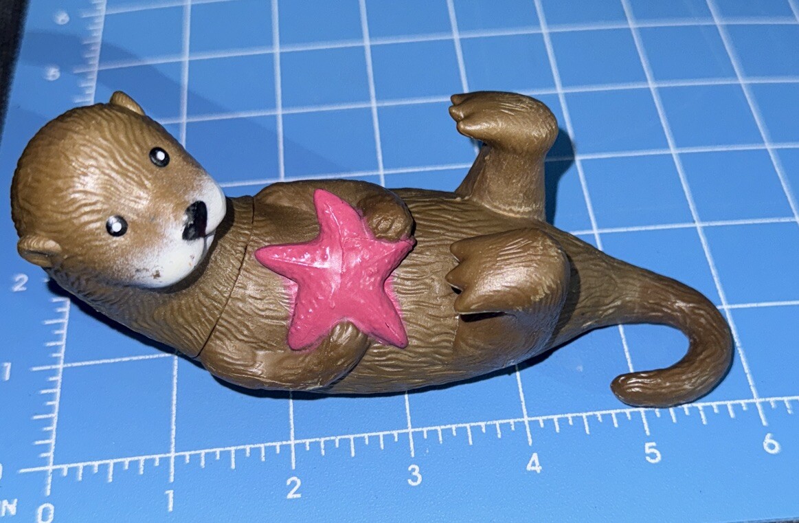 Ankyo Otter hard plastic figure holding a starfish lying on back 6″ long
