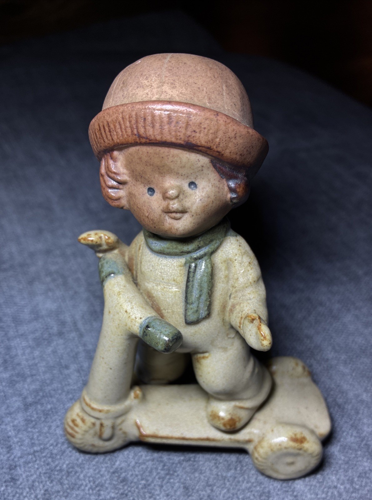 Vintage UCTCI Speckled Stoneware FIGURINE boy riding a scooter 1970’s Japan
