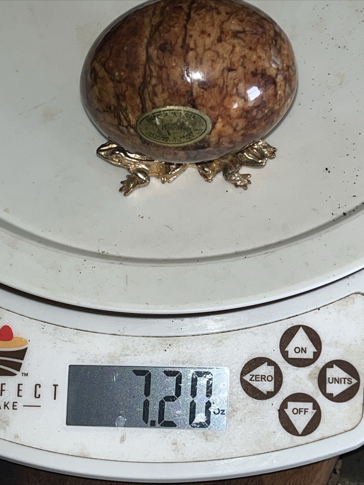 Alabaster stone egg on a metal stand