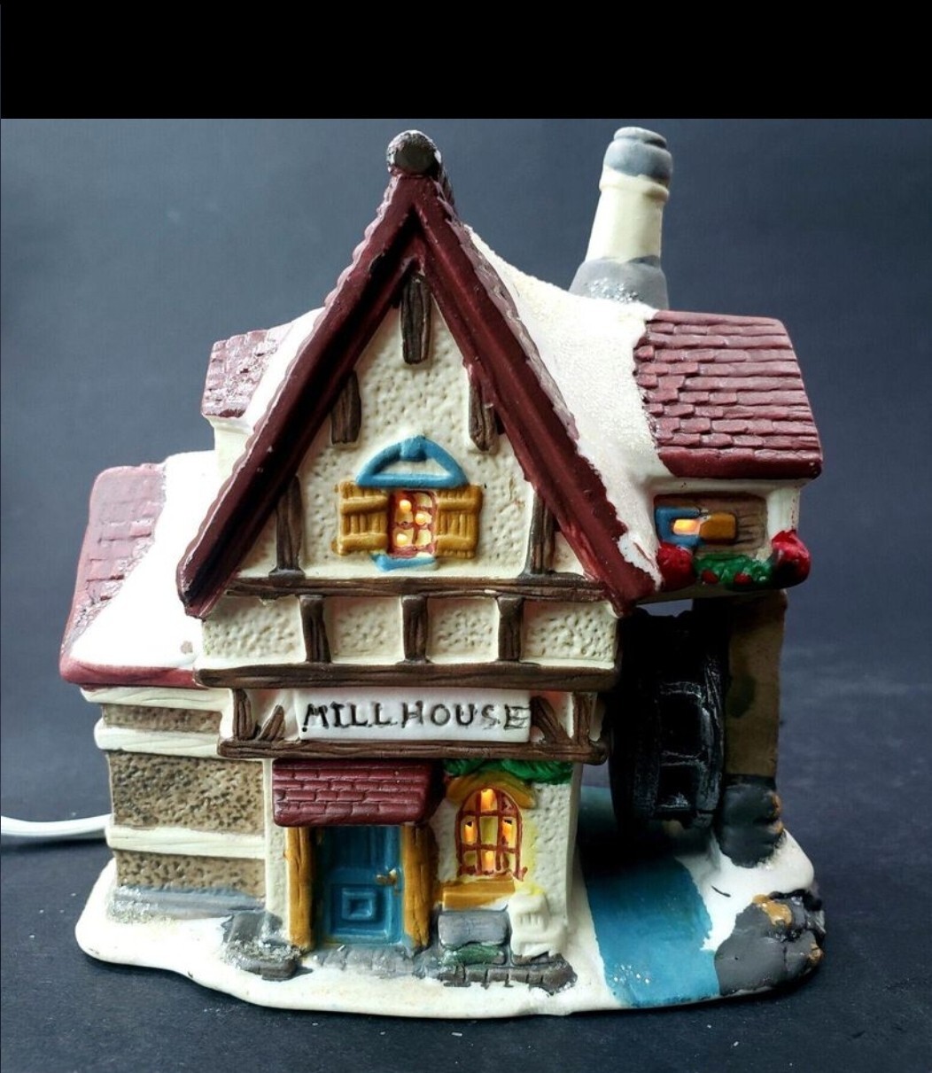 Charming Handcrafted Millhouse Figurine with Snow-Capped Roof and Flowing Water.