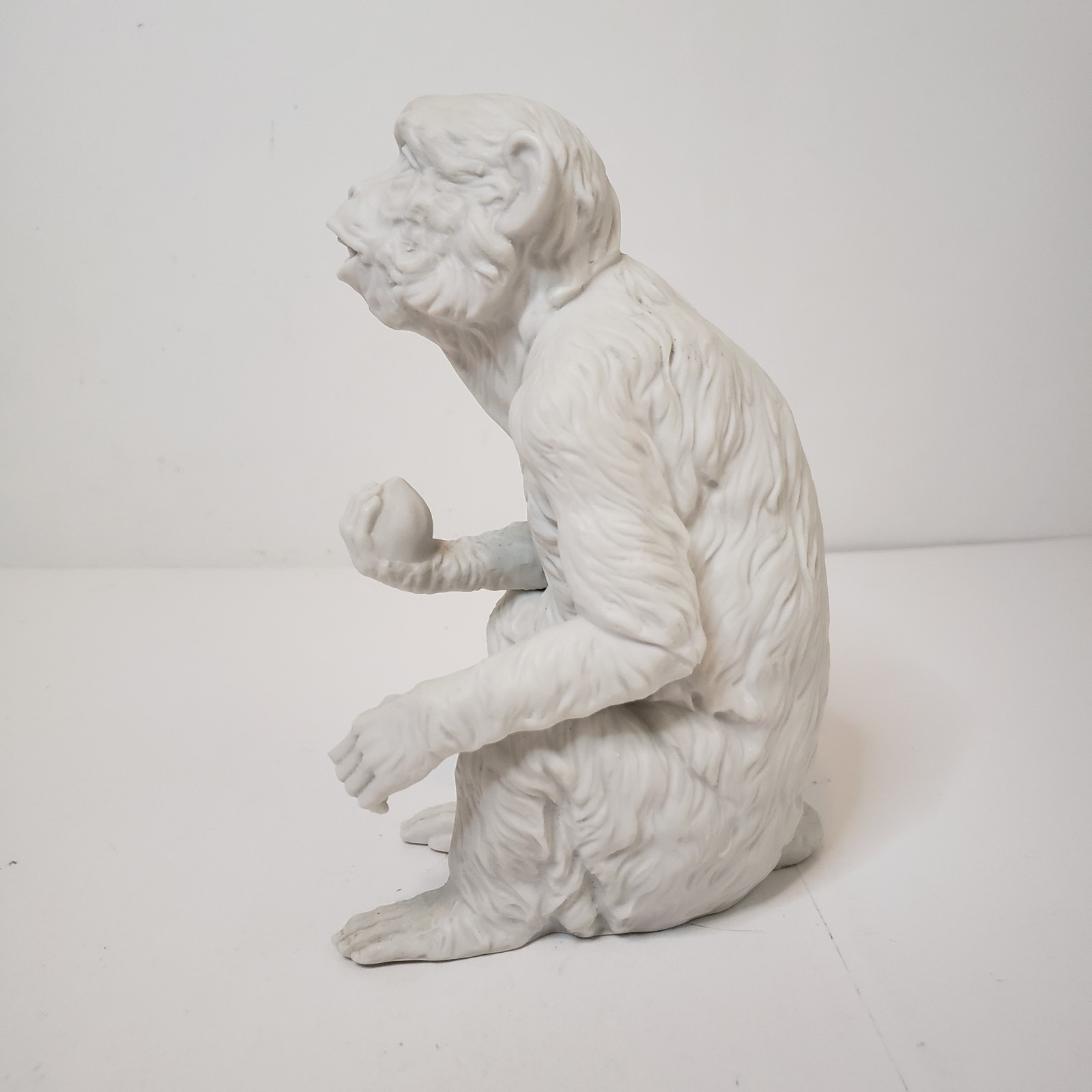 White Bisque Porcelain Sitting Monkey Holding Rock Figurine Vintage