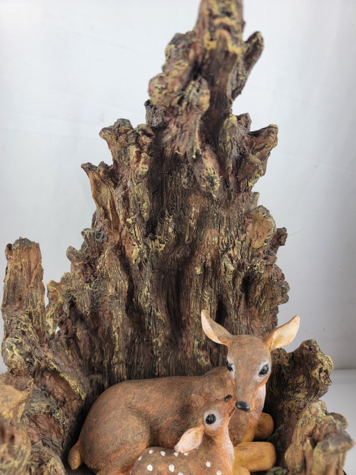 12″ Masterpiece Resin Deer, Fawn Resting Cave/ Tree Trunk Wodeen Base