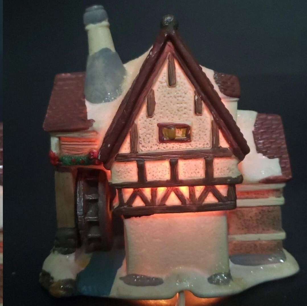 Charming Handcrafted Millhouse Figurine with Snow-Capped Roof and Flowing Water.