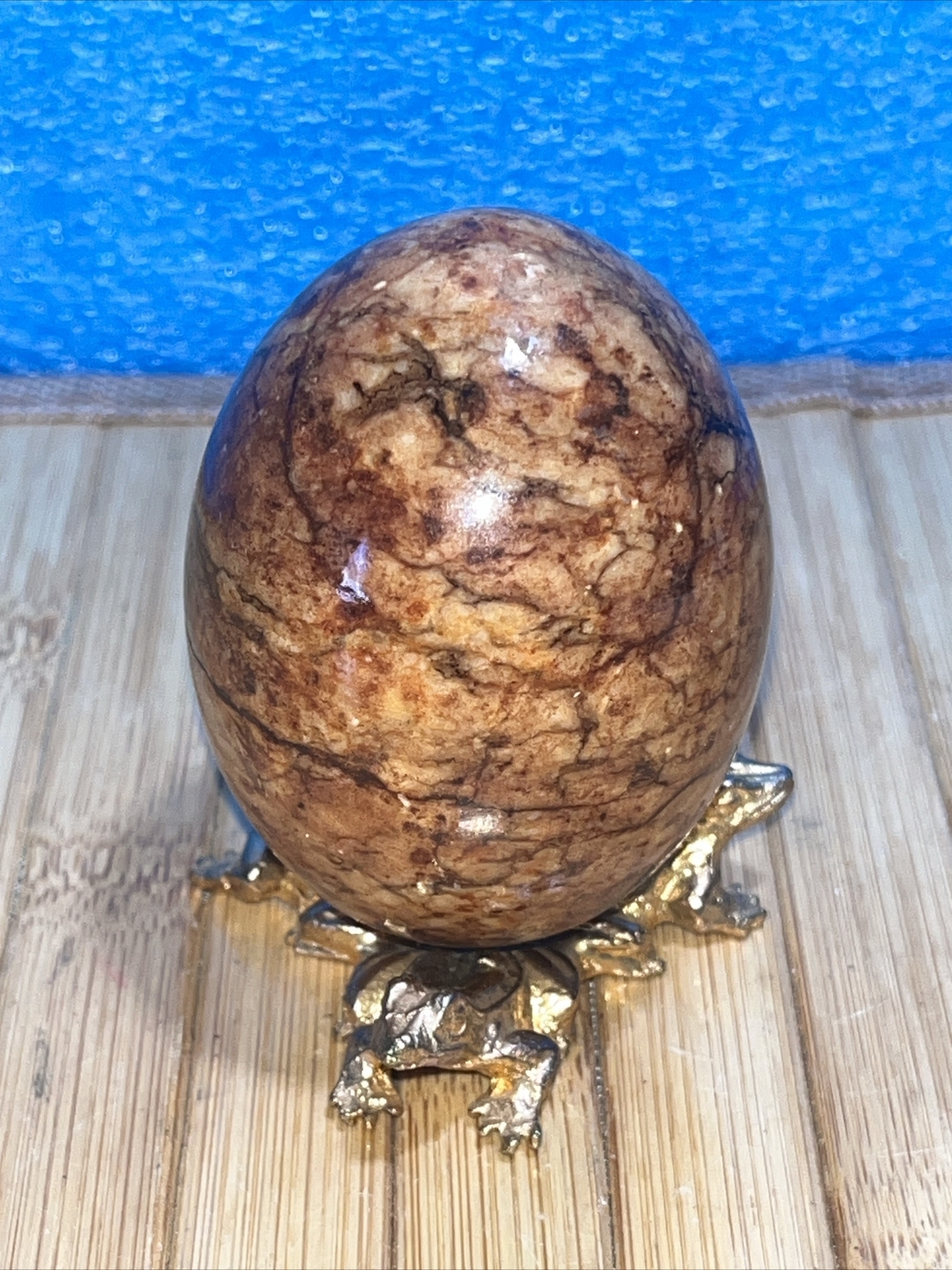 Alabaster stone egg on a metal stand
