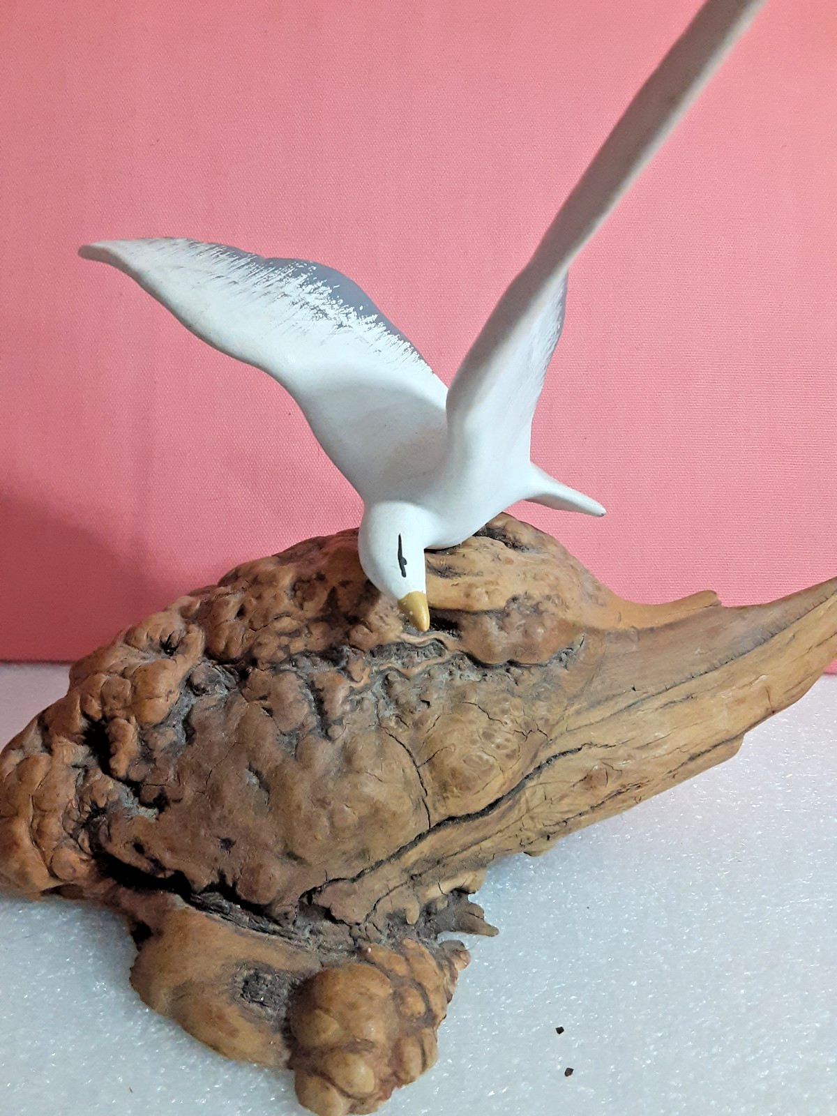 Seagull Flying Over A DriftWood Figurine