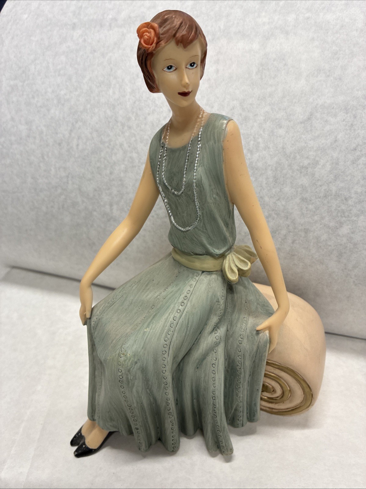 Vintage Art Deco Lady Figurine Sitting On Scroll With Beaded Necklace