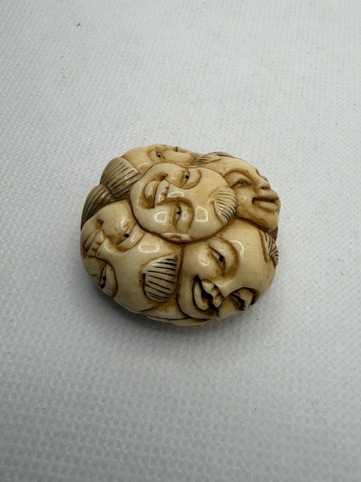 Japanese Carved Netsuke – Circular With Many Happy Faces And Geometric Shapes