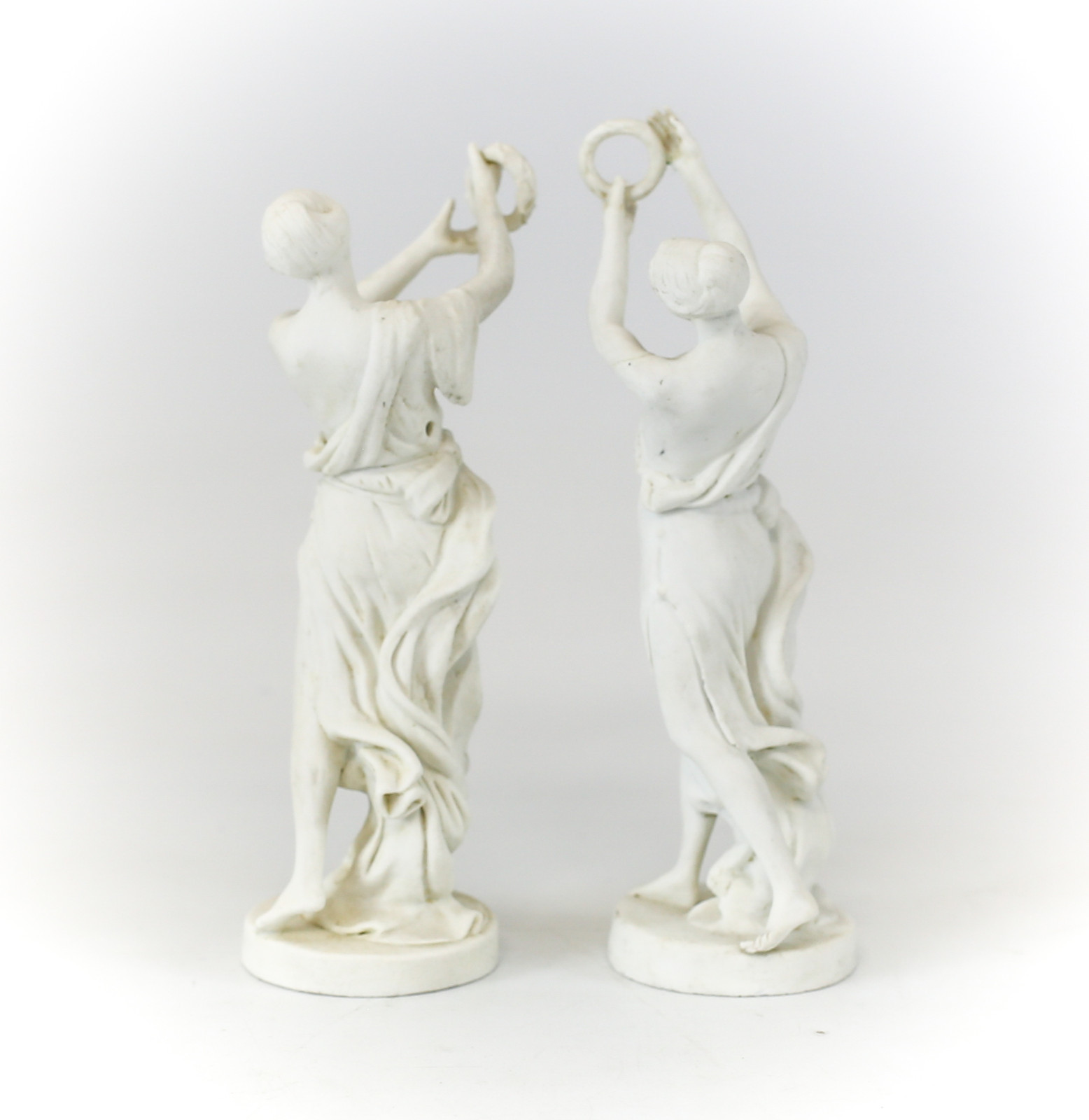 Pair of Sevres Bisque Porcelain Figurines of Women Deity Figures holding wreaths