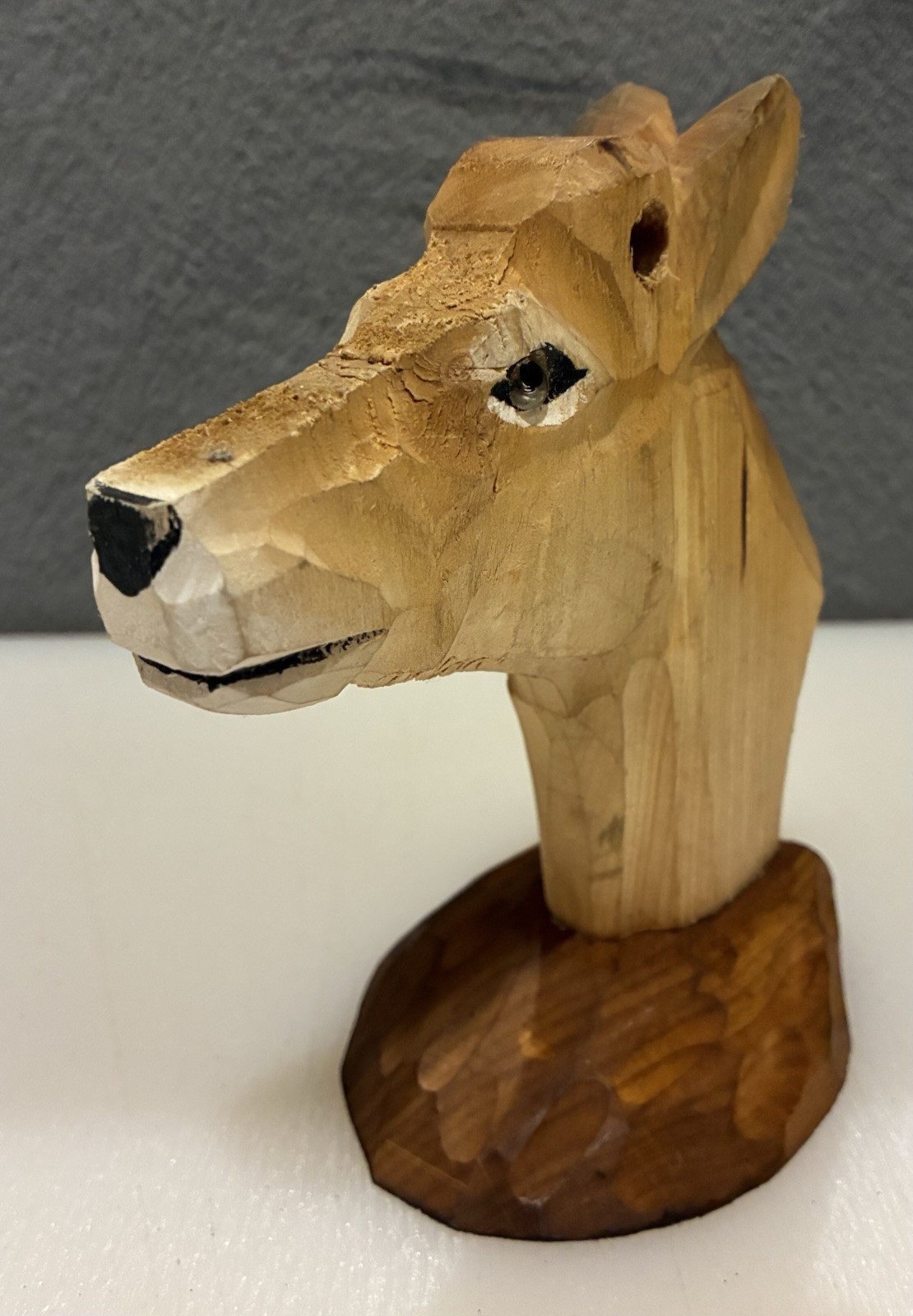 Hand carved wooden deer head with textured wood Base.