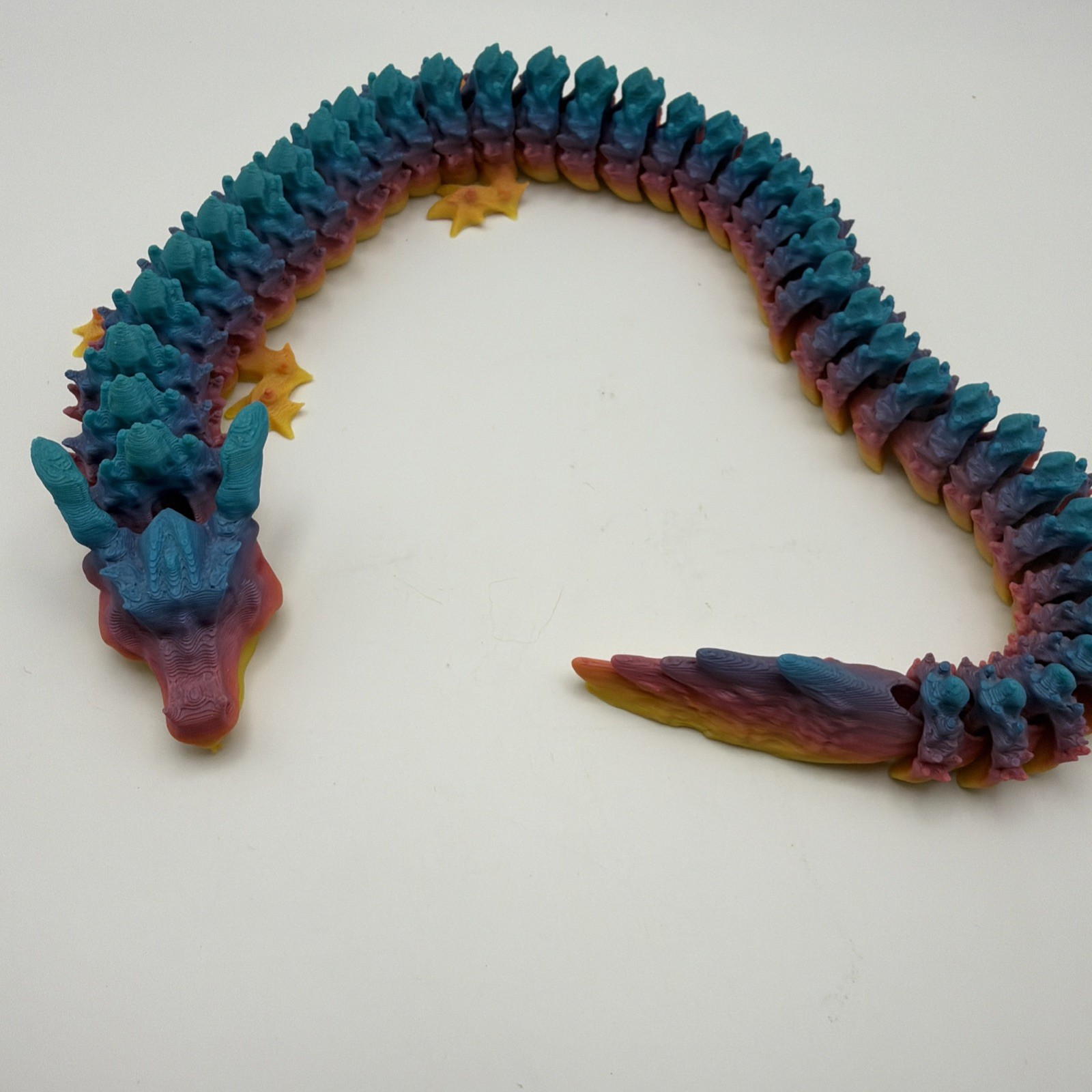 3d printed articulated dragon. Rainbow, articulating Dragon. 16 Inches long.