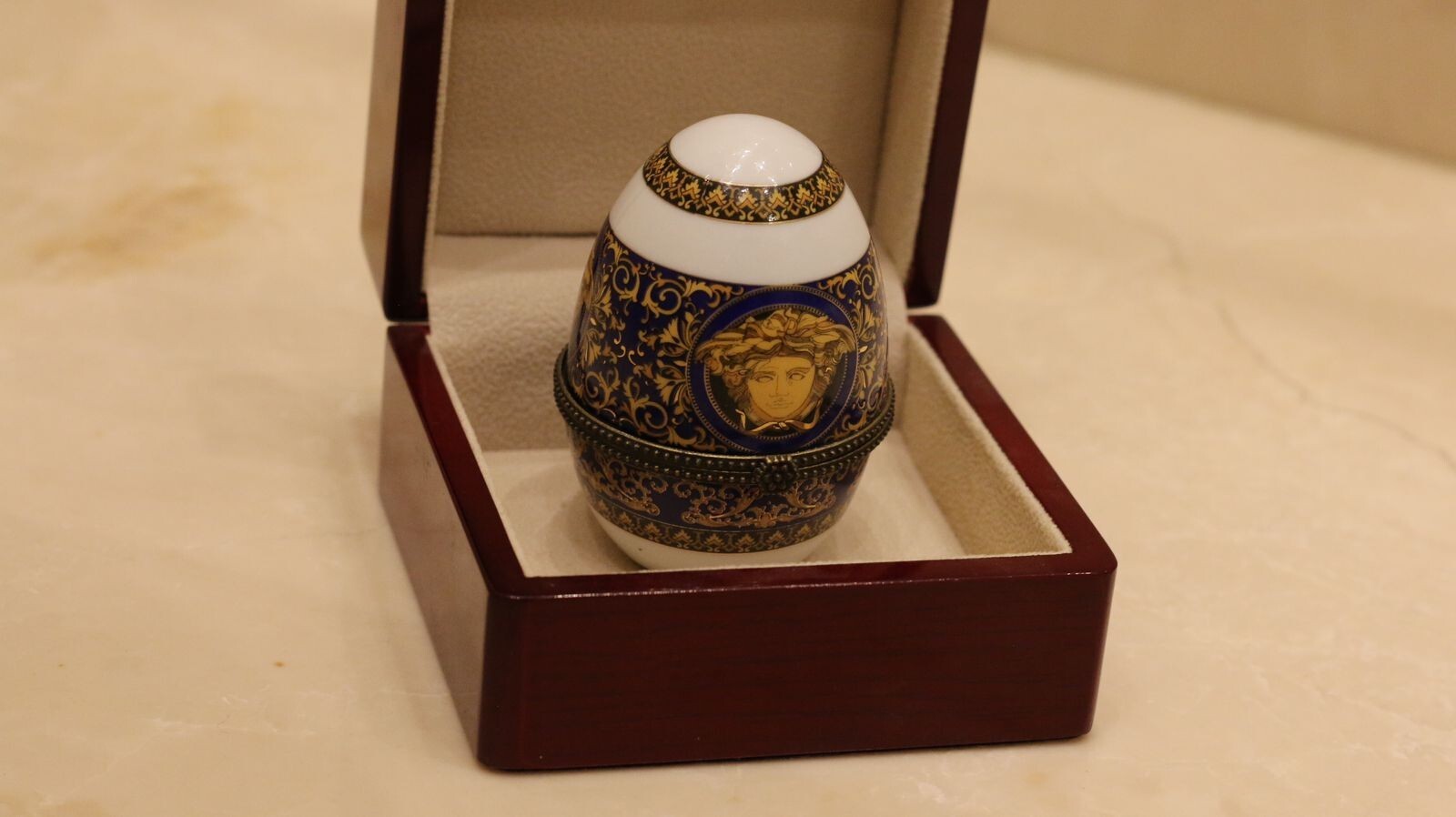 Versace Designs egg in white bohemian porcelain with blue and gold Medusa