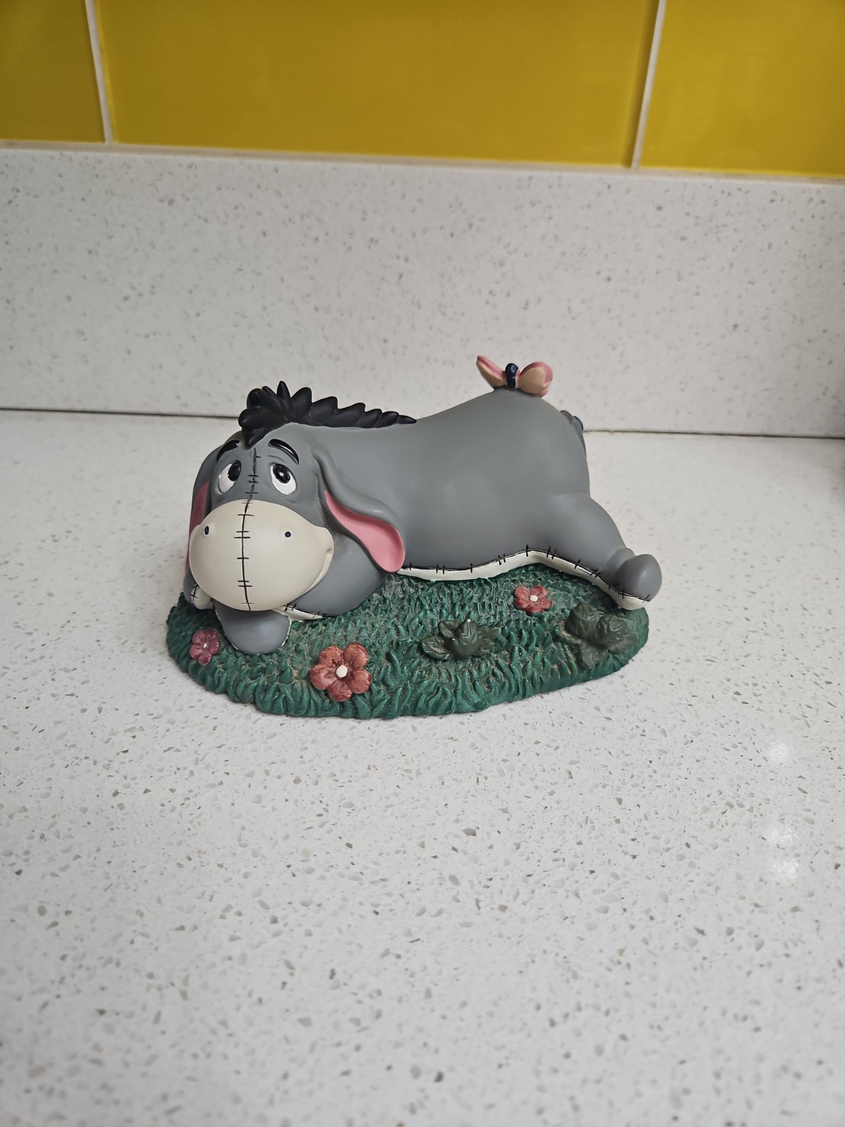 Disney Pooh & Friends “Eeyore Laying With Flowers ” Figurine 6” Long