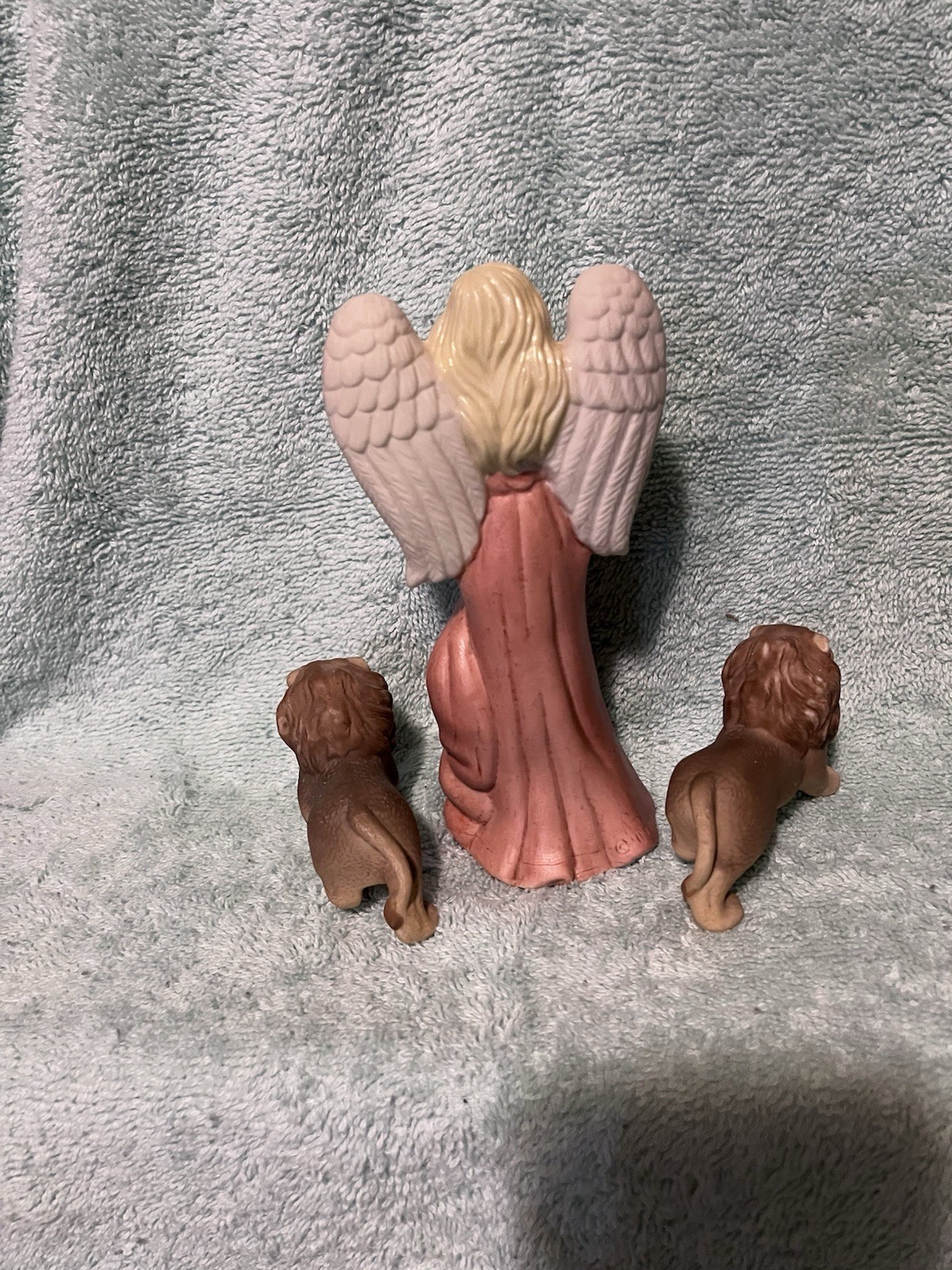 A Vintage Bisque Angle Figurine With Two Small Ceramic Lions