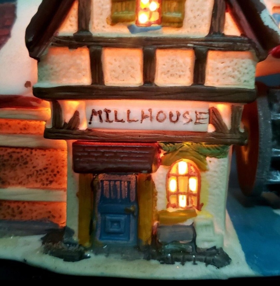 Charming Handcrafted Millhouse Figurine with Snow-Capped Roof and Flowing Water.