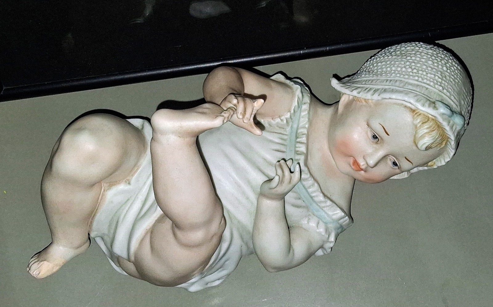 Gebruder Heubach-German Porcelain Bisque-Lying On Back Piano Baby–11″ Length