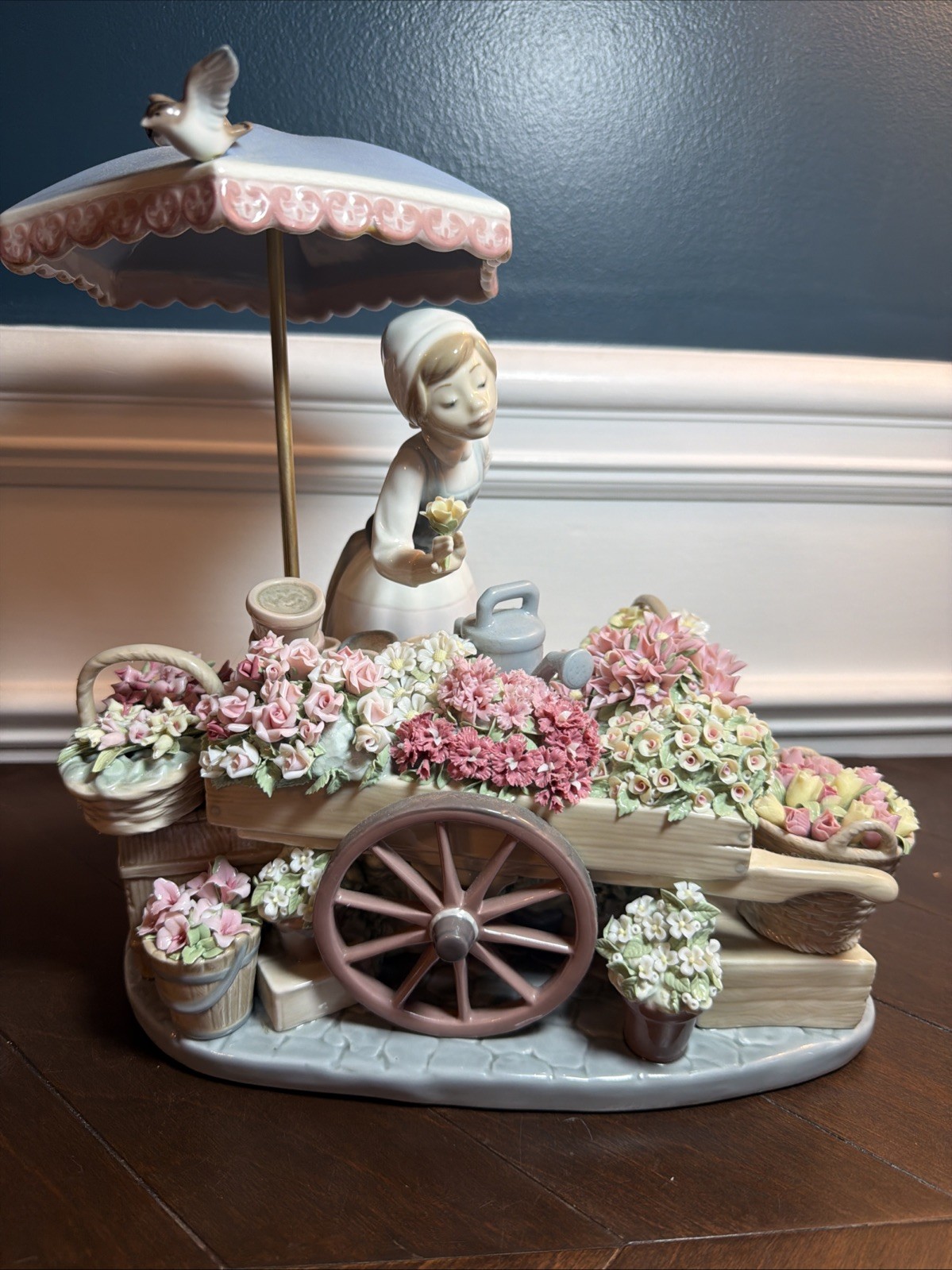 LLADRO; FLOWERS OF THE SEASON. GIRL WITH FLOWER CART, UMBRELLA AND BIRDS
