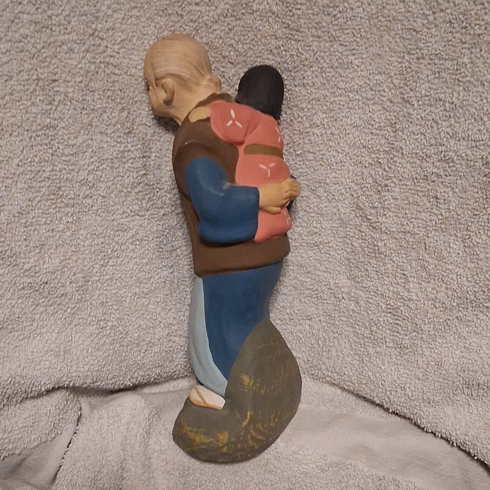 Uncommon Ceramic Hand Painted Figurine Of An Elderly Man Carrying A Small Child