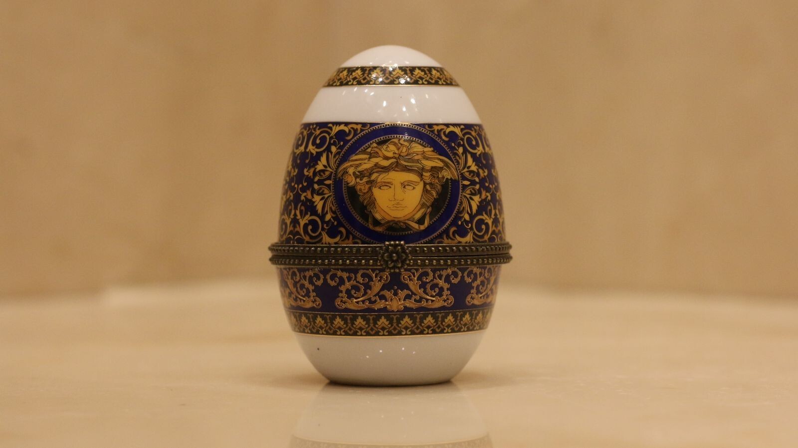 Versace Designs egg in white bohemian porcelain with blue and gold Medusa