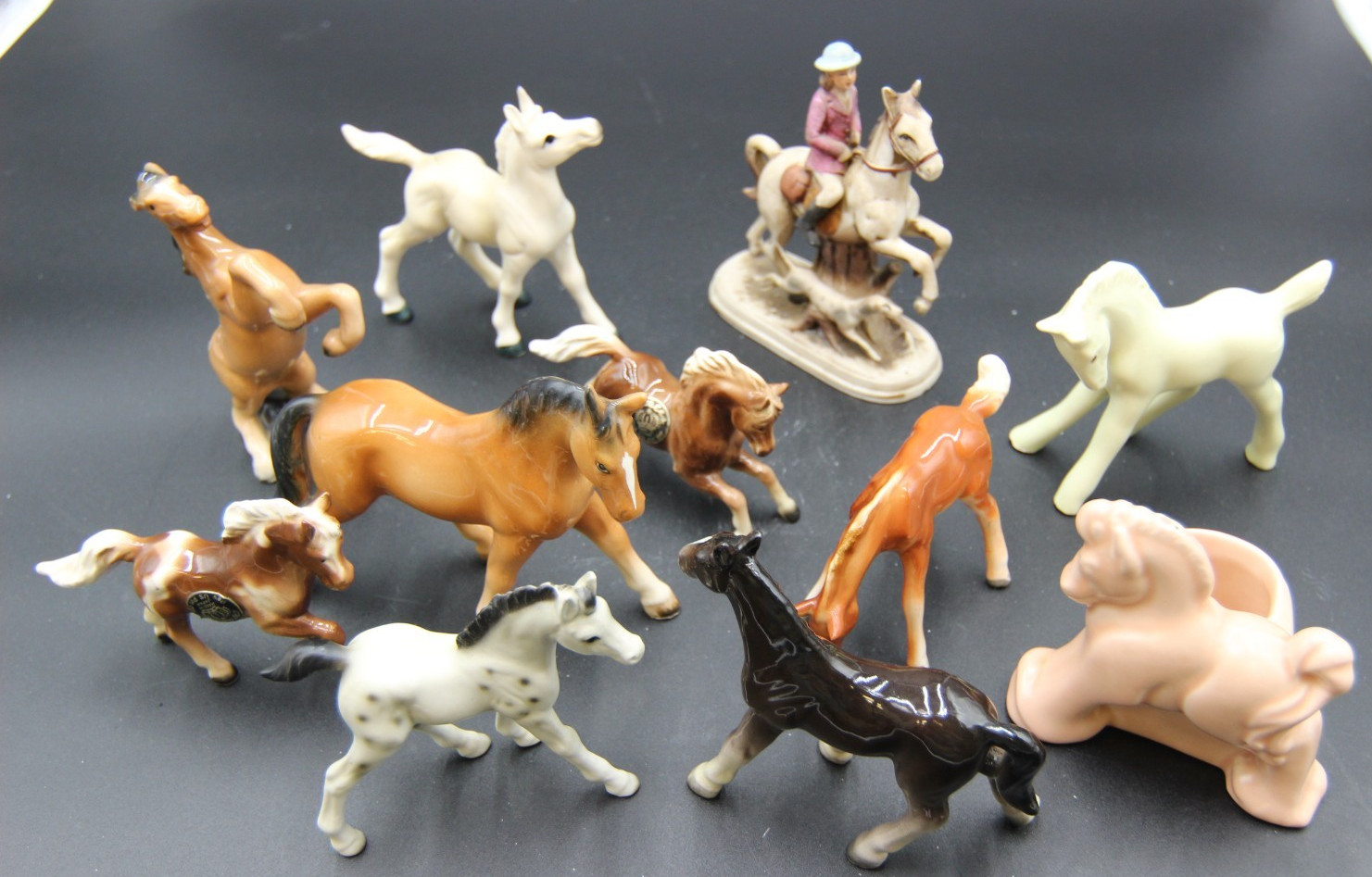 Collection of Porcelain Horse Figurines in Various Poses, Colors, and Sizes