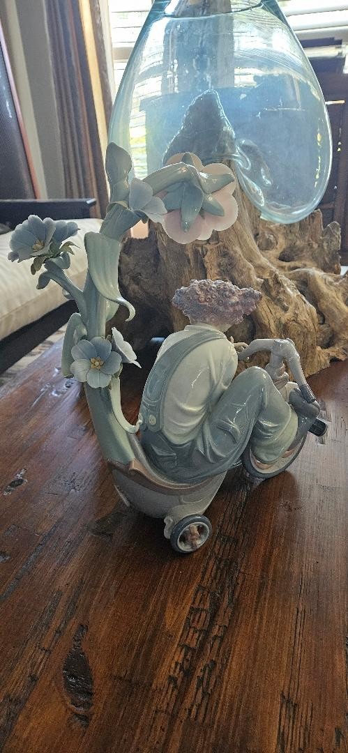 A World of Magic limited edition Lladro with two missing flowers and a pedal