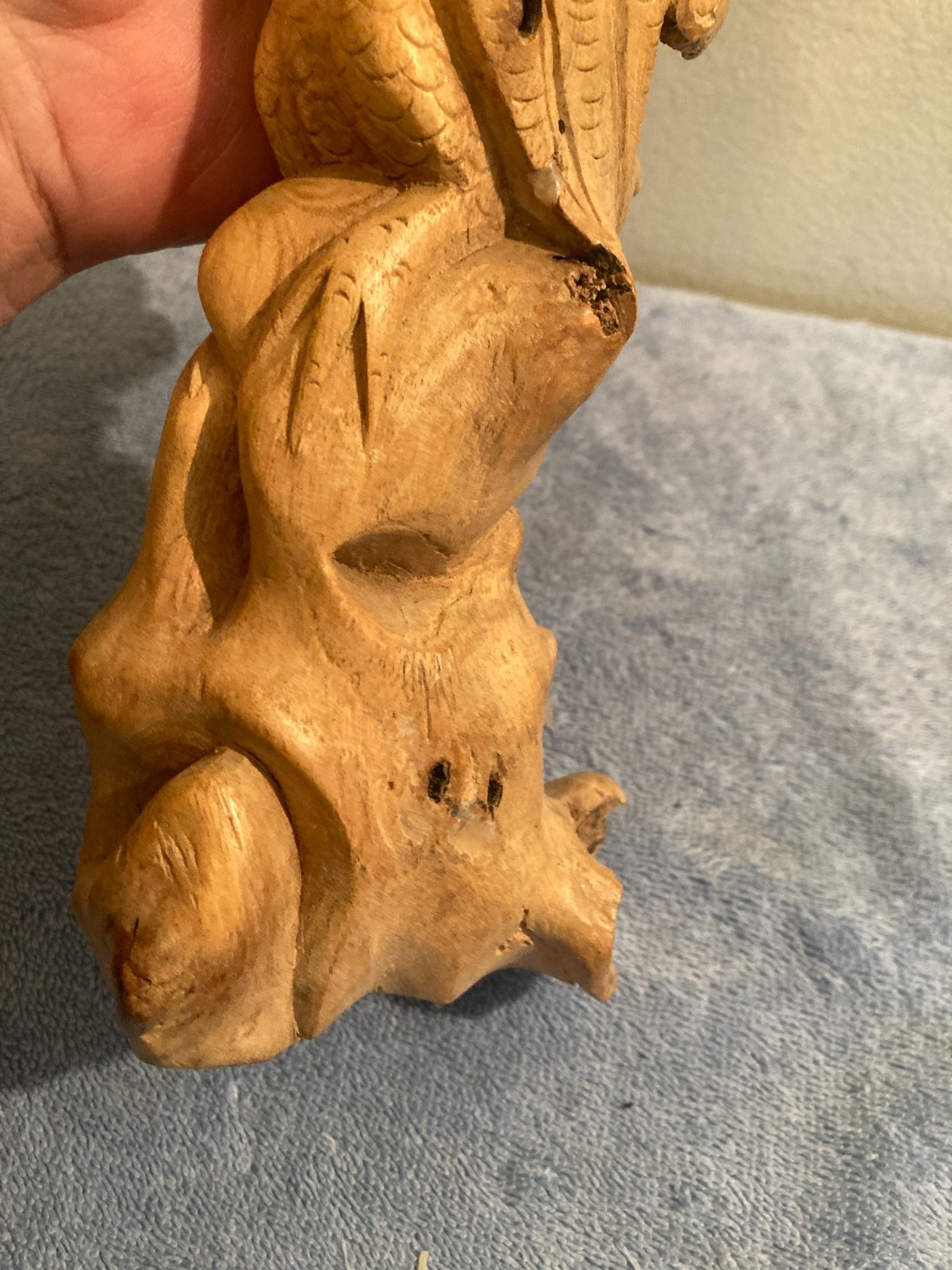 Owl bird statue hand carved from yellow natural wood with natural wood cracks