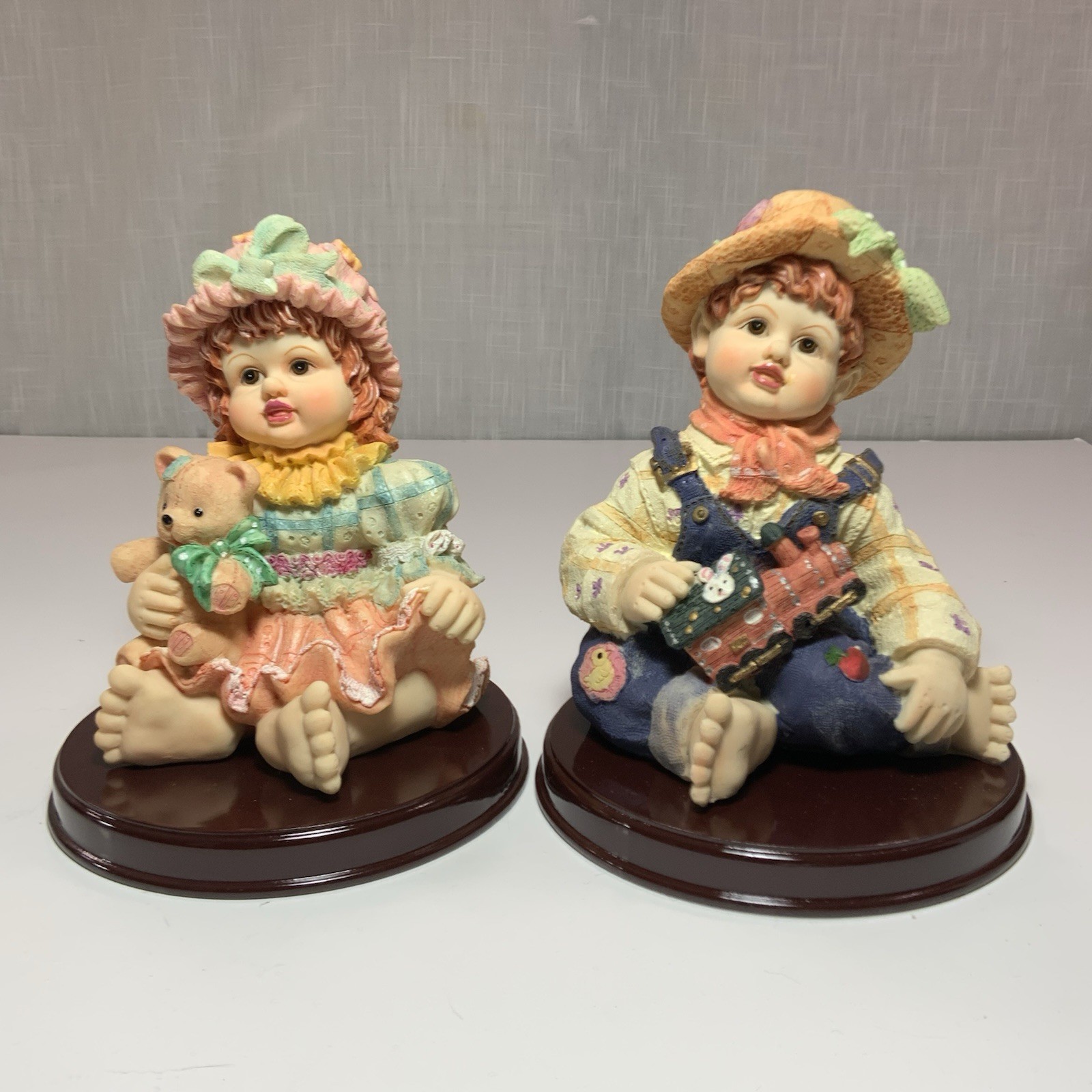 Vin Resin Figurines of a Boy and a Girl Reddish Hair Brown Eyes 7 1/2 from1980’s